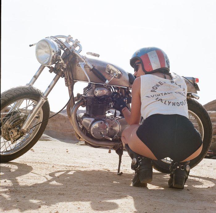 A playful frame from Girls on a motorcycle — online in Bakoor